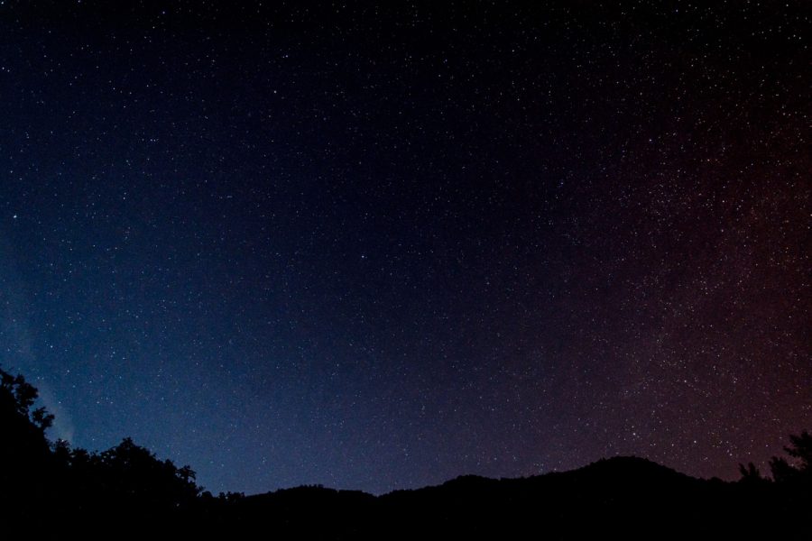 Star-filled night sky over a dark hillside silhouette in Cyprus